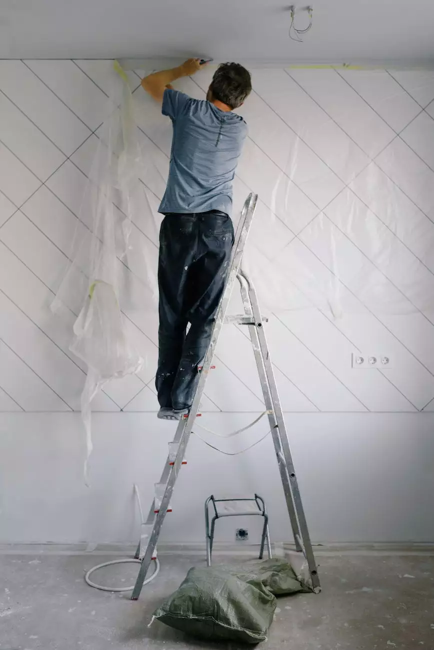 Interior wall preparation with a worker on a ladder