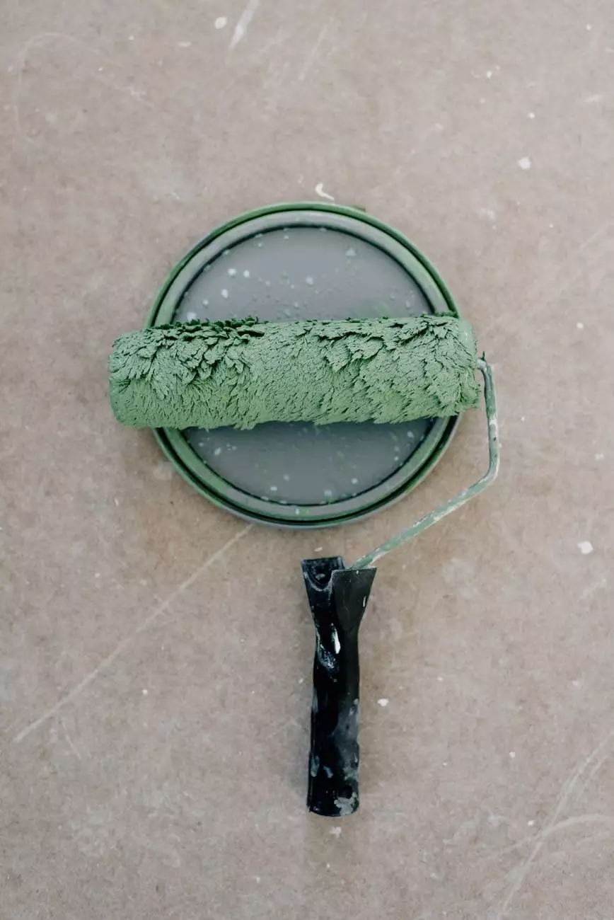 Paint roller and paint tray on a concrete surface